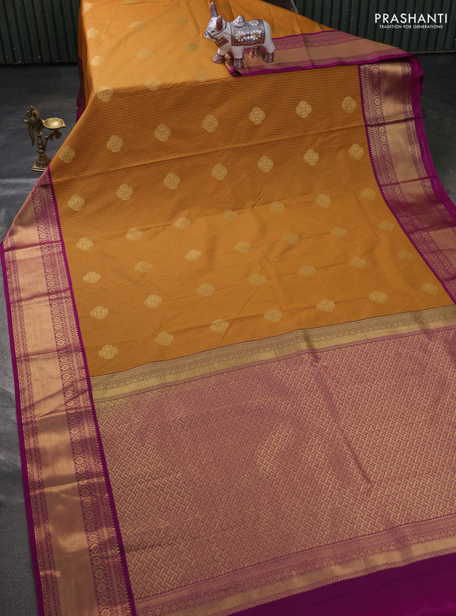 Semi kanchipuram silk saree dark mustard and pink with allover zari weaves & buttas and zari woven korvai border