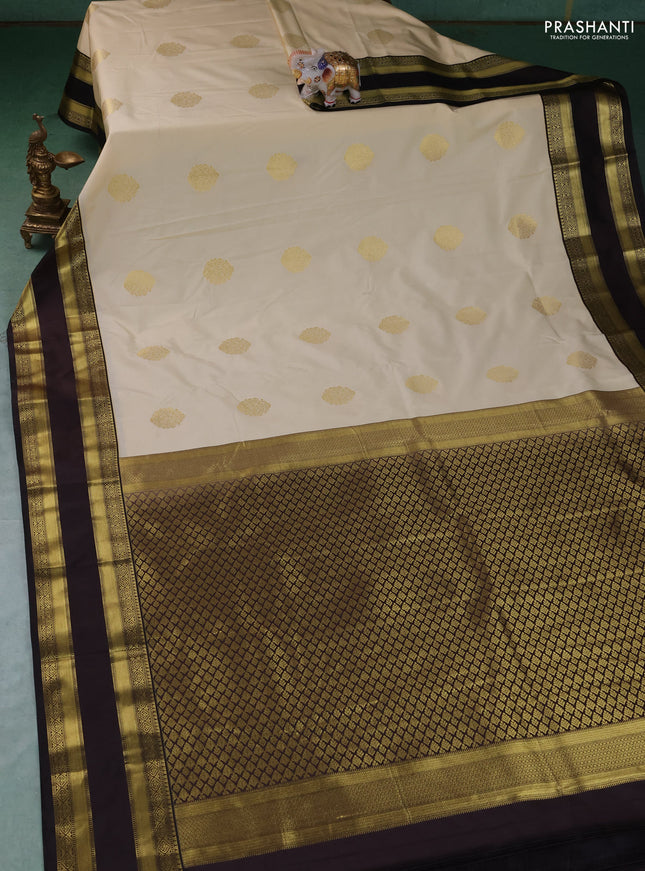 Semi kanchipuram silk saree cream and black with zari woven buttas and rettapet zari woven border