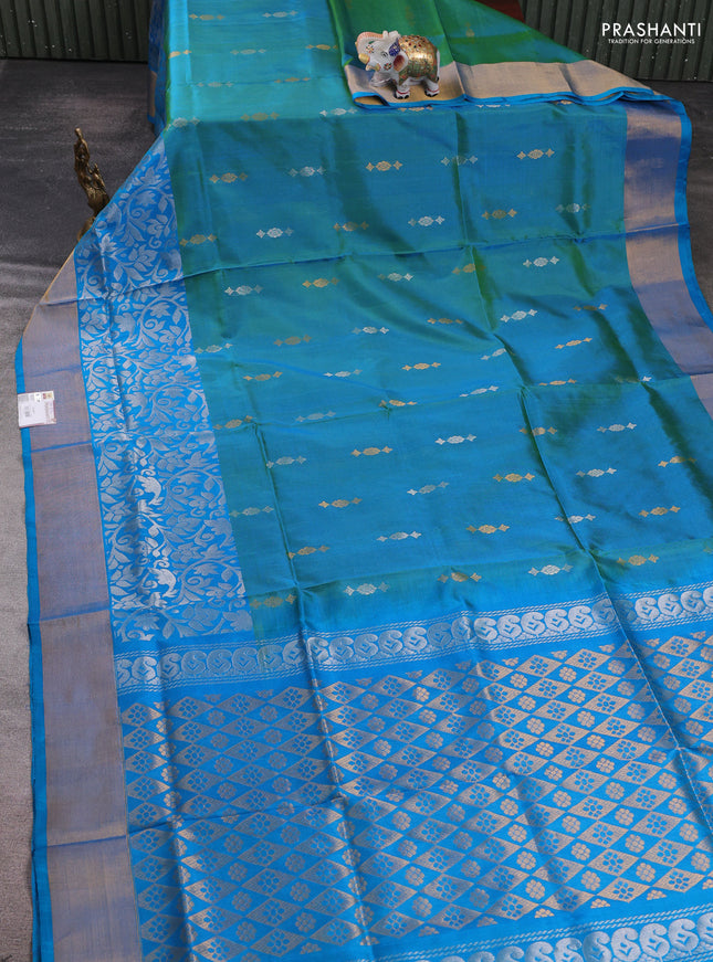 Pure uppada silk saree dual shade of teal green and teal blue with allover silver & zari woven buttas and long zari woven border