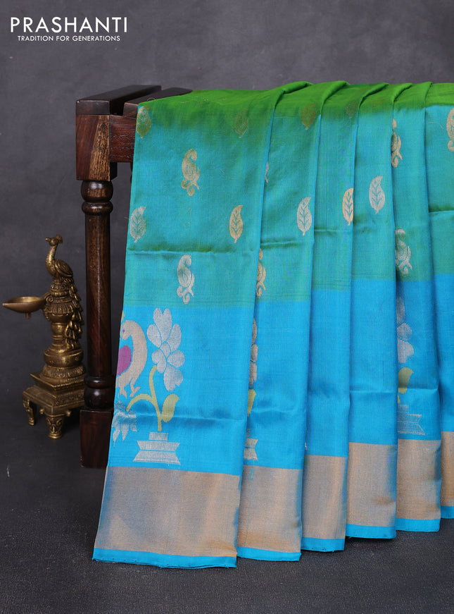 Pure uppada silk saree dual shade of teal green and teal blue with allover silver & zari woven buttas and peacock design zari woven border