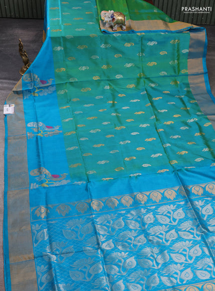 Pure uppada silk saree dual shade of teal green and teal blue with allover silver & zari woven buttas and peacock design zari woven border