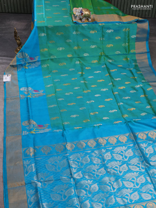 Pure uppada silk saree dual shade of teal green and teal blue with allover silver & zari woven buttas and peacock design zari woven border