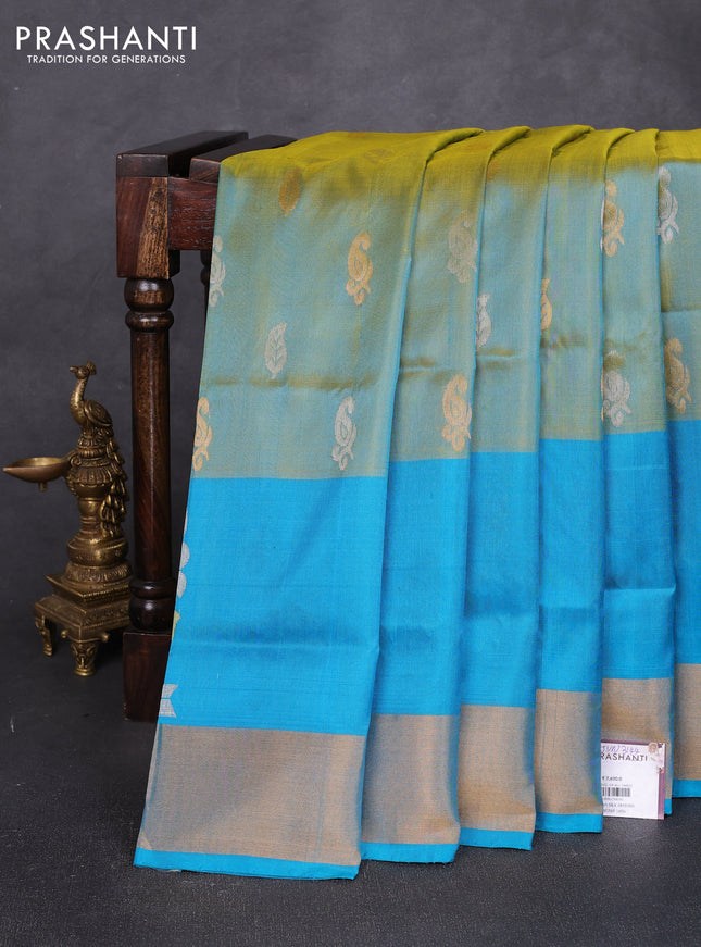 Pure uppada silk saree dual shade of greenish yellow and teal blue with allover silver & zari woven buttas and peacock zari woven butta border
