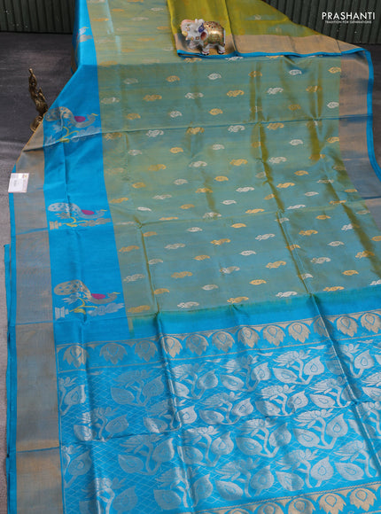 Pure uppada silk saree dual shade of greenish yellow and teal blue with allover silver & zari woven buttas and peacock zari woven butta border
