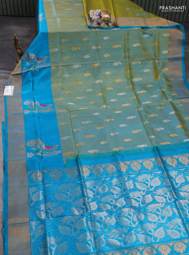 Pure uppada silk saree dual shade of greenish yellow and teal blue with allover silver & zari woven buttas and peacock zari woven butta border