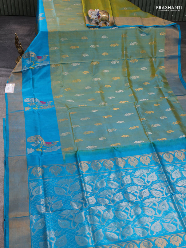Pure uppada silk saree dual shade of greenish yellow and teal blue with allover silver & zari woven buttas and peacock zari woven butta border