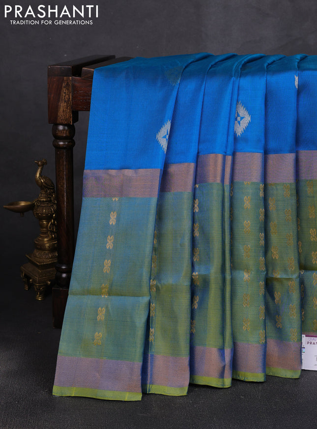 Pure uppada silk saree cs blue and dual shade of light green with allover zari woven buttas and long zari woven butta border