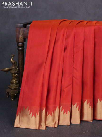 Pure kanchipuram silk saree rust shade with plain body and temple zari woven border