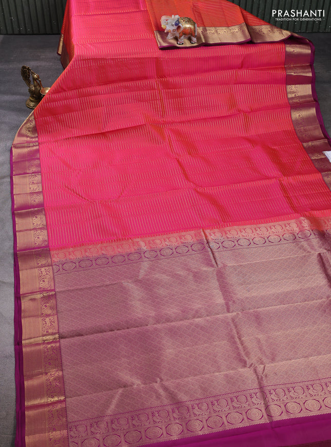 Pure kanchipuram silk saree dual shade of pinkish orange and pink with allover zari stripe pattern and zari woven border