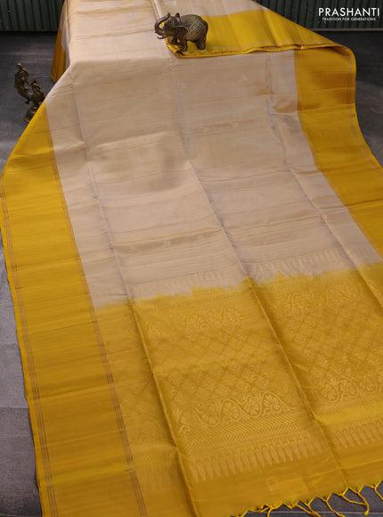 Pure soft silk saree beige and yellow with zari woven buttas and rettapet zari woven border