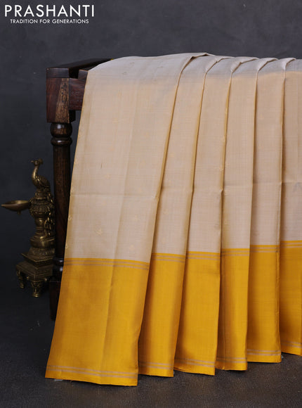 Pure soft silk saree beige and yellow with allover zari woven buttas and rettapet zari woven border