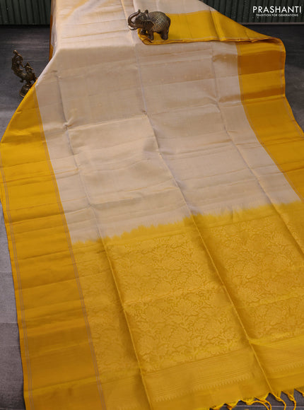Pure soft silk saree beige and yellow with allover zari woven buttas and rettapet zari woven border