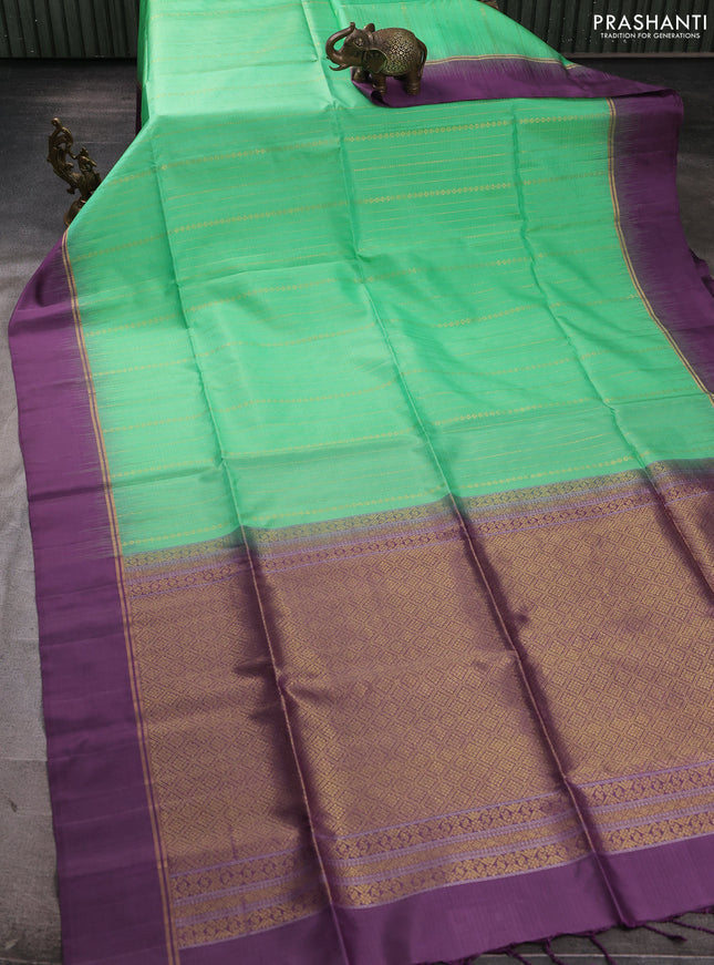 Pure soft silk saree teal green and purple with allover zari weaves  and zari woven simple border
