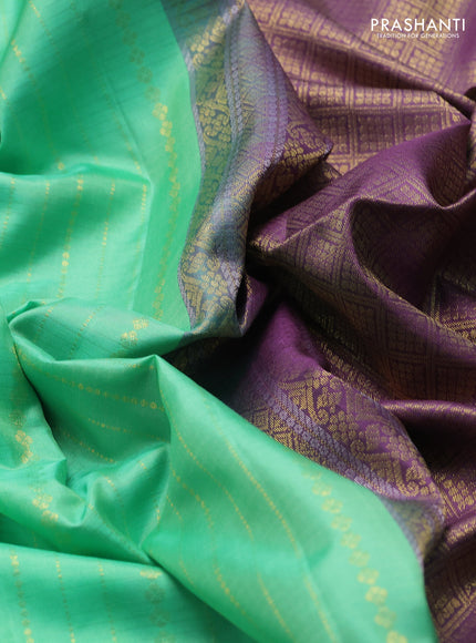 Pure soft silk saree teal green and purple with allover zari weaves  and zari woven simple border