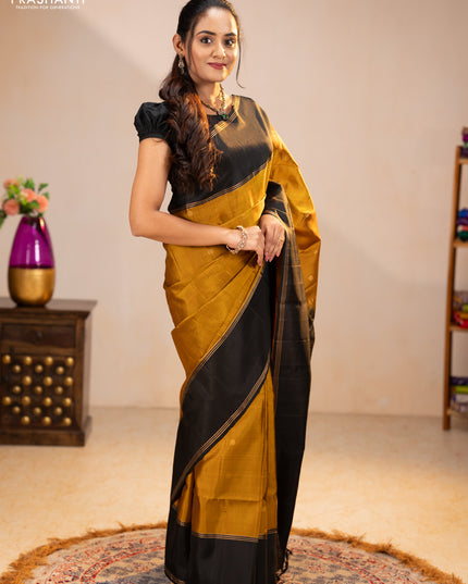 Pure soft silk saree dark mustard and black with zari woven buttas and rettapet zari woven border