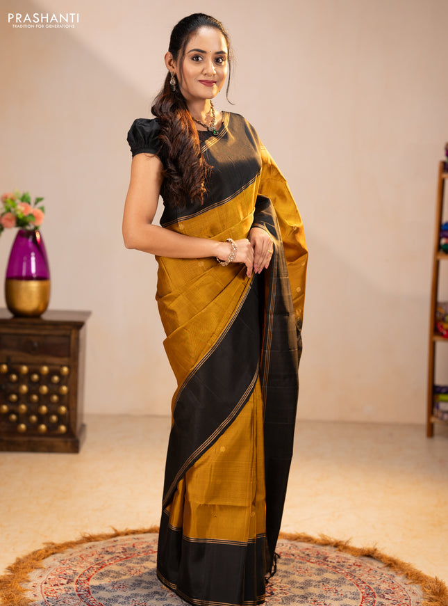 Pure soft silk saree dark mustard and black with zari woven buttas and rettapet zari woven border