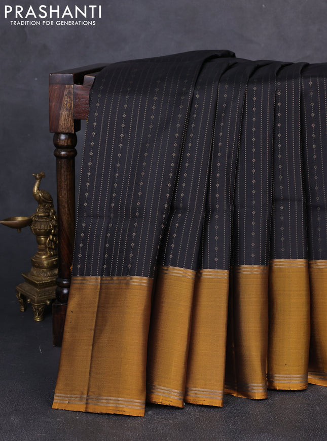 Pure soft silk saree black and dark mustard with allover zari weaves and long rettapet zari woven border