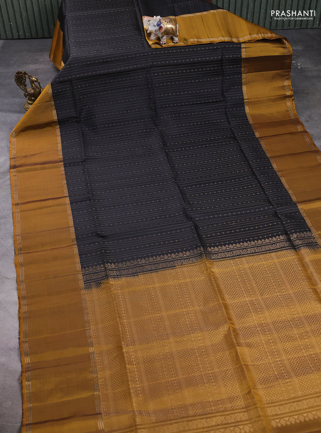 Pure soft silk saree black and dark mustard with allover zari weaves and long rettapet zari woven border