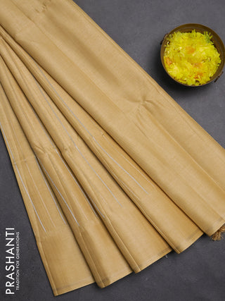 Semi tussar saree sandal with allover silver & zari weaves pattern and simple zari woven border