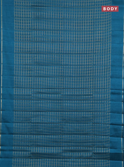 Semi tussar saree peacock green with allover zari checks and simple zari woven border