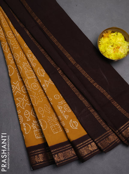 Sungudi cotton saree mustard yellow and coffee brown with allover batik prints and zari woven border
