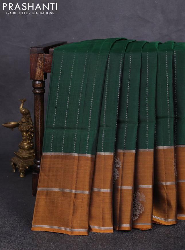 Kanchipuram soft silk saree bottle green and mustard yellow with allover silver zari weaves and long zari woven butta border