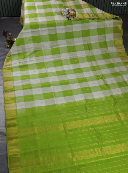 Silk cotton saree cream and light green with allover paalum pazhamum checks & zari buttas and zari woven border
