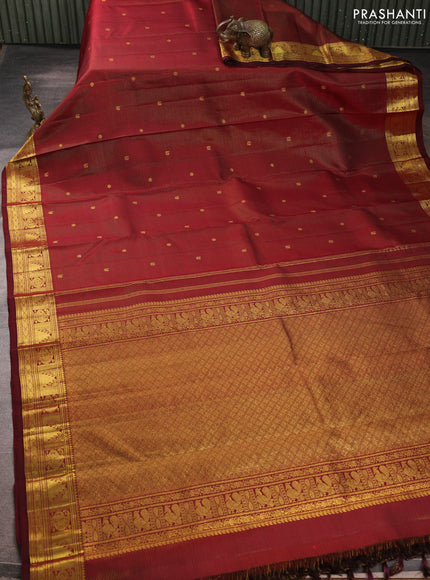 Pure kanchipurams silk saree maroon with allover vairaosi pattern & zari buttas and temple & paisley zari woven border