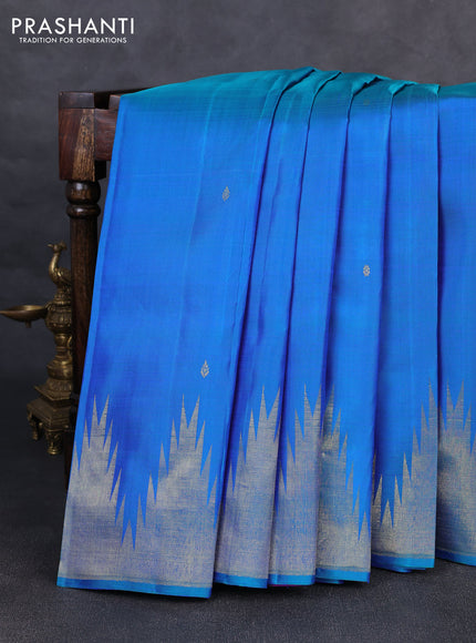 Pure kanchipurams silk saree dual shade of bluish green and purple with zari woven buttas and temple design zari woven border