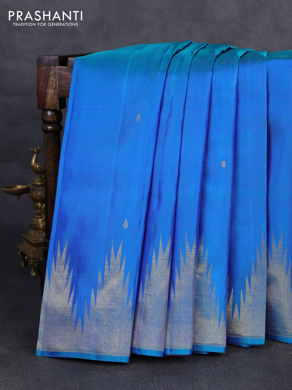 Pure kanchipurams silk saree dual shade of bluish green and purple with zari woven buttas and temple design zari woven border