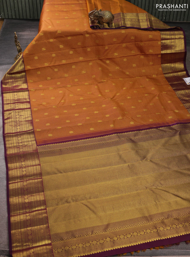 Pure kanchipurams silk saree dark mustard and deep purple with allover small zari checks & buttas and long zari woven border