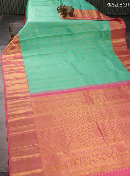 Pure kanchipurams silk saree teal blue and peach pink with allover small zari checks & buttas and long zari woven border