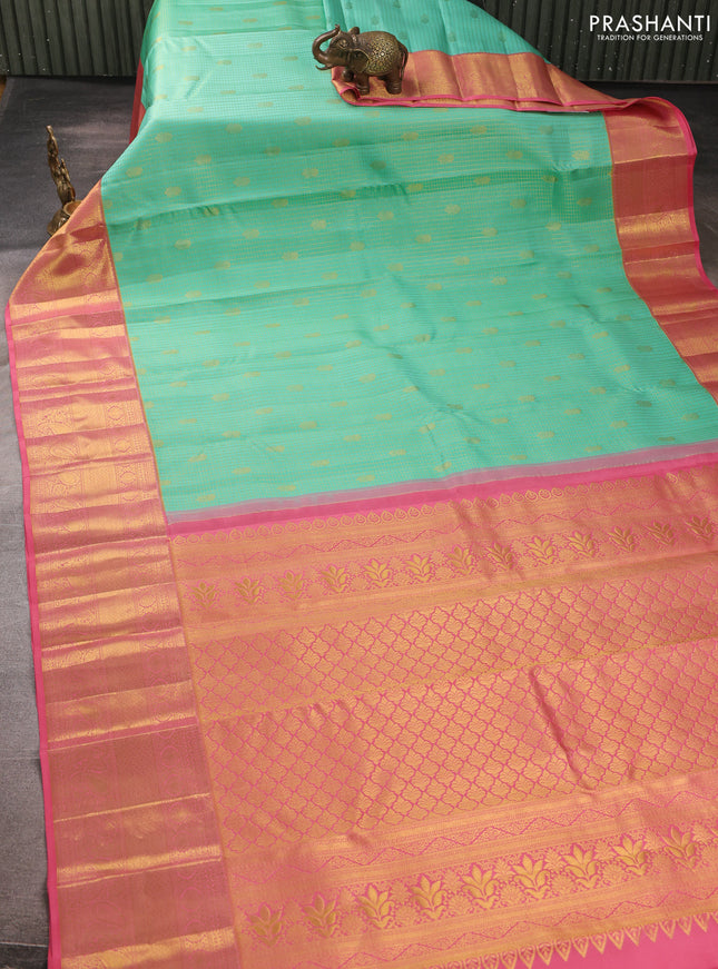 Pure kanchipurams silk saree teal blue and peach pink with allover small zari checks & buttas and long zari woven border