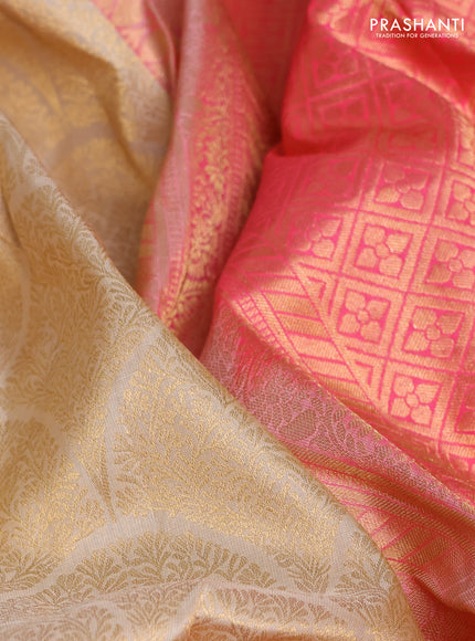 Pure kanchipuram silk saree cream and peach pink with allover zari woven brocade weaves and rich zari woven korvai border
