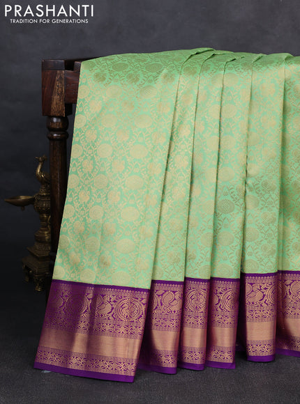 Pure kanchipuram silk saree pista green and purple with allover zari woven brocade weaves and rich zari woven korvai border