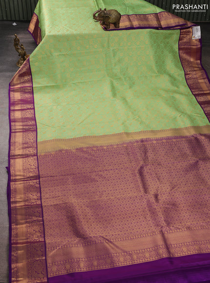 Pure kanchipuram silk saree pista green and purple with allover zari woven brocade weaves and rich zari woven korvai border