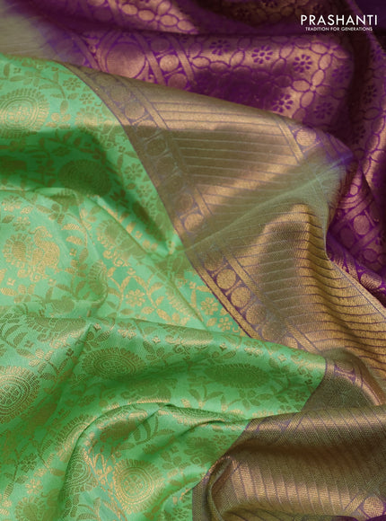 Pure kanchipuram silk saree pista green and purple with allover zari woven brocade weaves and rich zari woven korvai border
