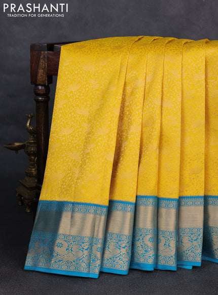 Pure kanchipuram silk saree yellow and cs blue with allover zari woven brocade weaves and rich zari woven korvai border