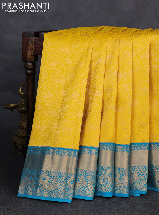 Pure kanchipuram silk saree yellow and cs blue with allover zari woven brocade weaves and rich zari woven korvai border