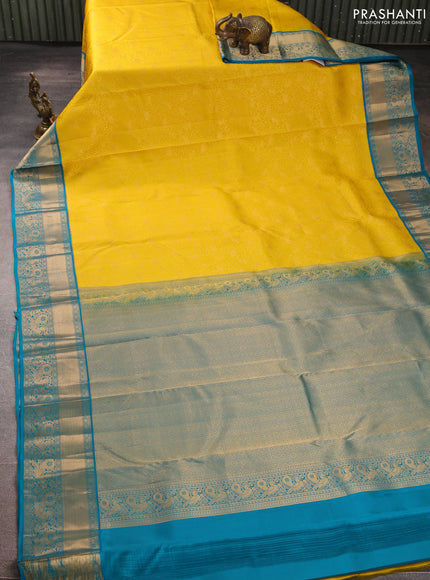 Pure kanchipuram silk saree yellow and cs blue with allover zari woven brocade weaves and rich zari woven korvai border