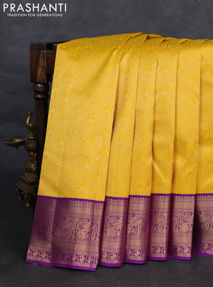Pure kanchipuram silk saree yellow and purple with allover zari woven brocade weaves and rich zari woven korvai border