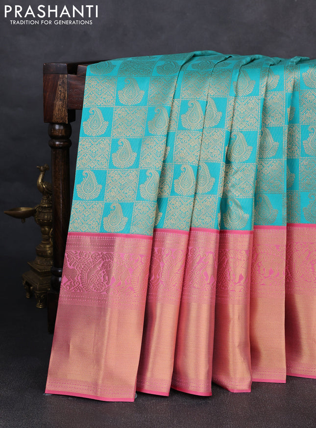 Pure kanchipuram silk saree teal blue and peach pink with allover zari woven brocade weaves and long rich zari woven korvai border