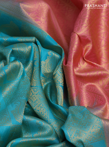 Pure kanchipuram silk saree teal blue and peach pink with allover zari woven brocade weaves and long rich zari woven korvai border