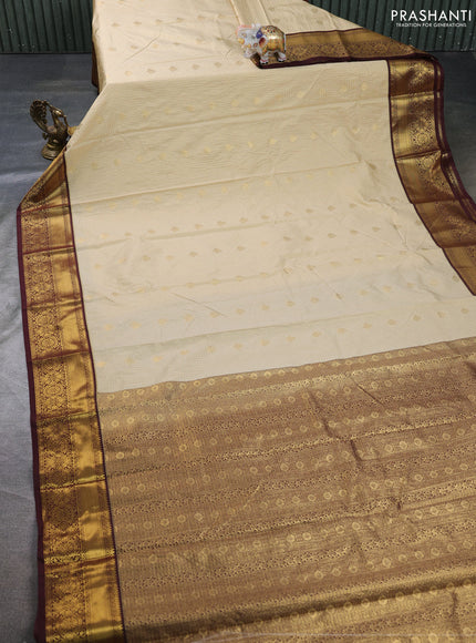 Semi kanchipuram silk saree cream and deep maroon with allover zari checks & buttas and zari woven border