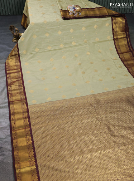 Semi kanchipuram silk saree pista green and coffee brown with allover zari weaves & buttas and rettapet zari woven border