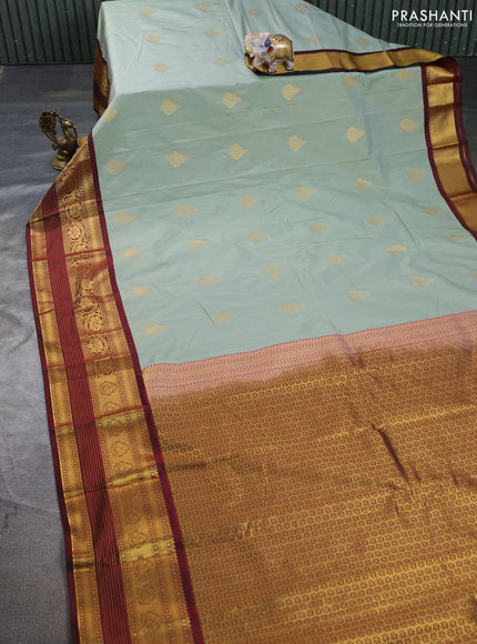 Semi kanchipuram silk saree pastel green and deep maroon with allover zari weaves & buttas and long zari woven korvai border