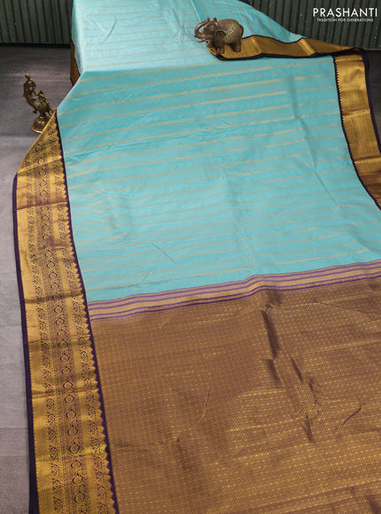Semi kanchipuram silk saree teal blue and deep purple with allover zari woven buttas and zari woven korvai border