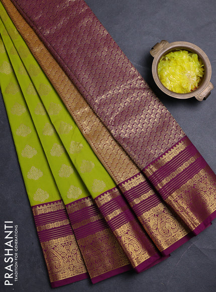 Semi kanchipuram silk saree light green and purple with allover zari woven buttas and zari woven korvai border