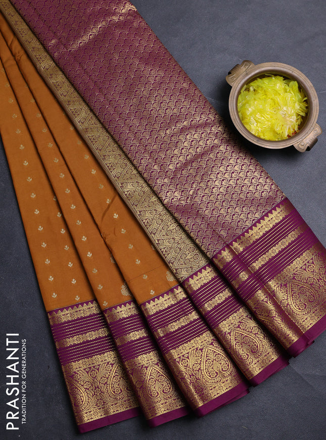 Semi kanchipuram silk saree dark mustard and purple with allover zari woven buttas and zari woven korvai border