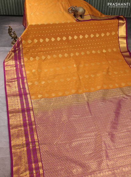 Semi kanchipuram silk saree dark mustard and purple with allover zari woven buttas and zari woven korvai border
